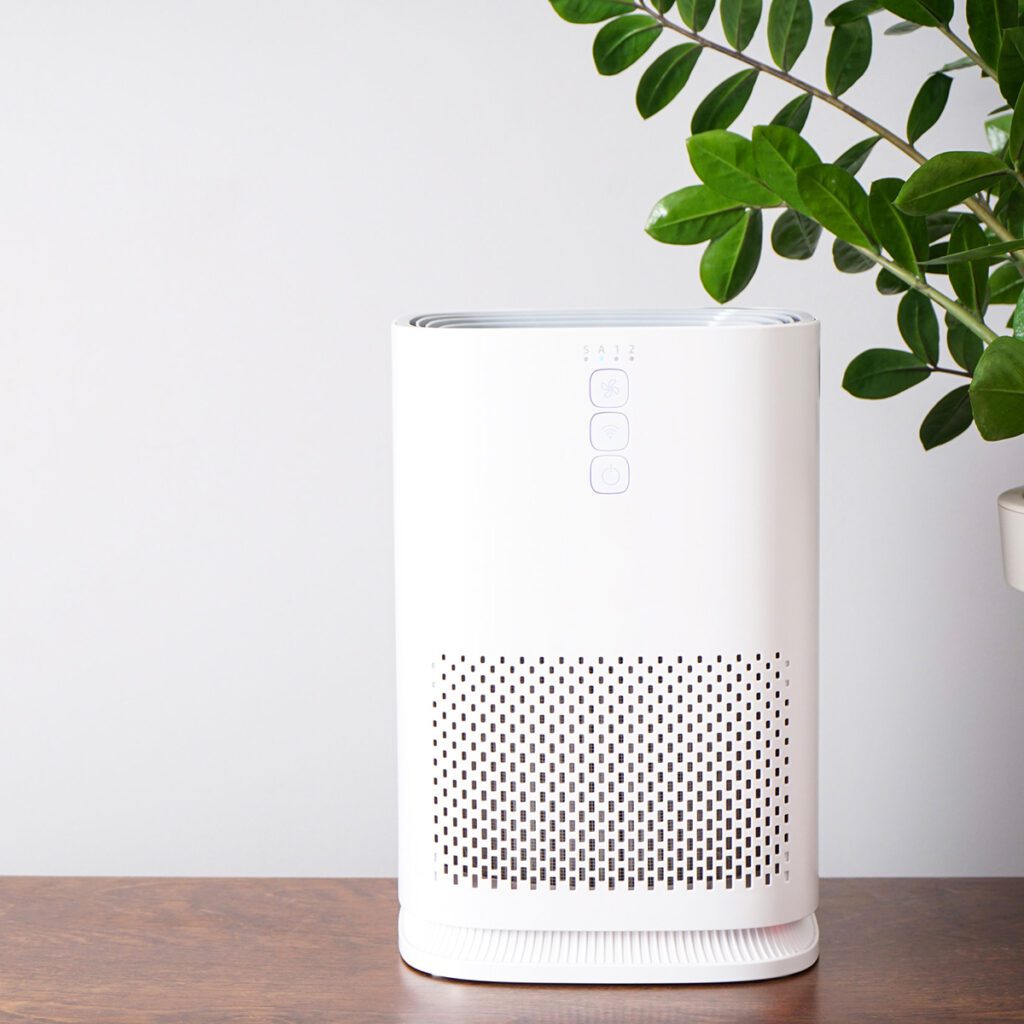 A white air purifier sitting on top of a table.