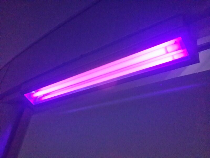 A purple light is on in the ceiling.