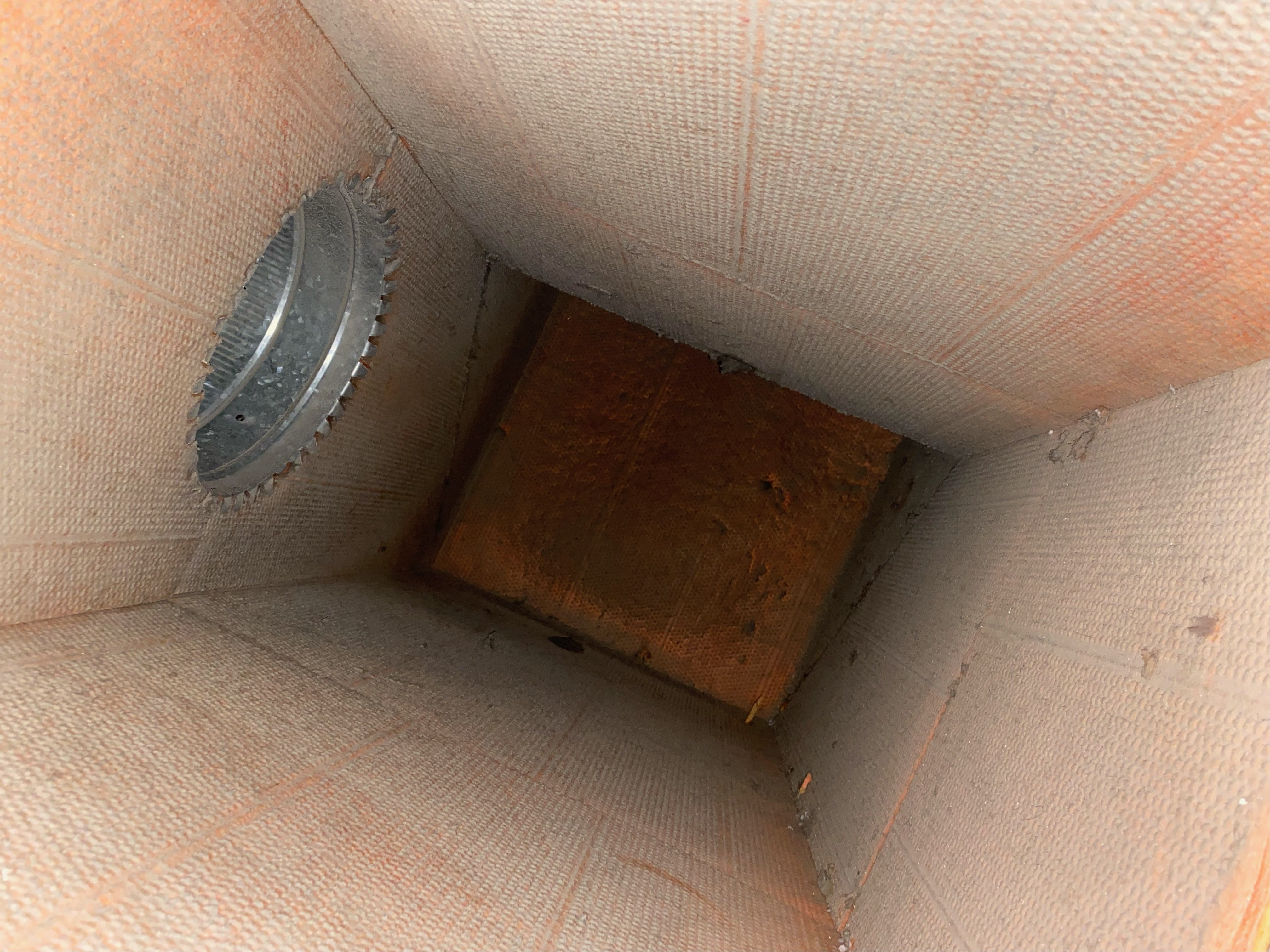 A view of the inside of a box with a hole in it.